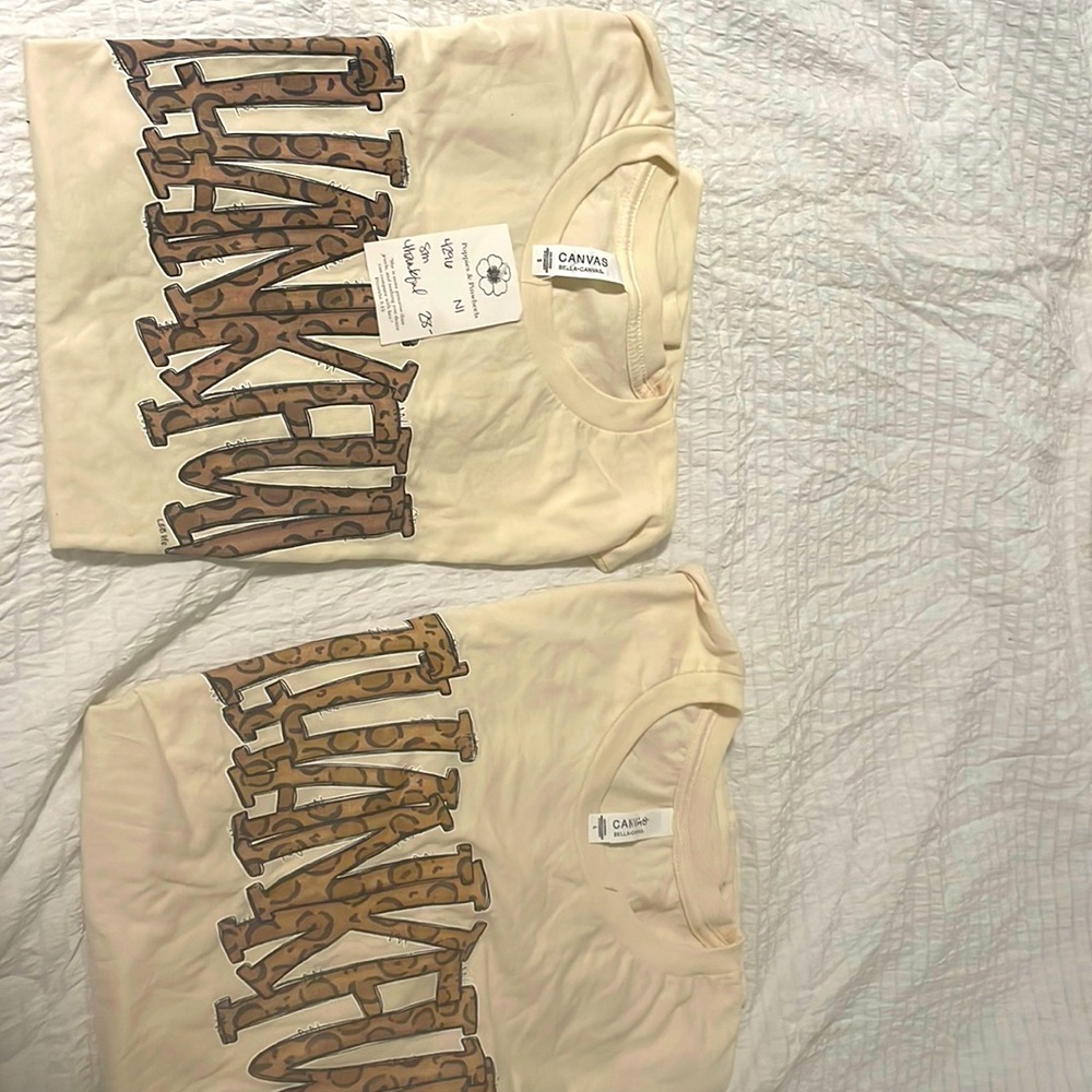 Two cute T-shirts one size small and the other one size large good 4 holidays